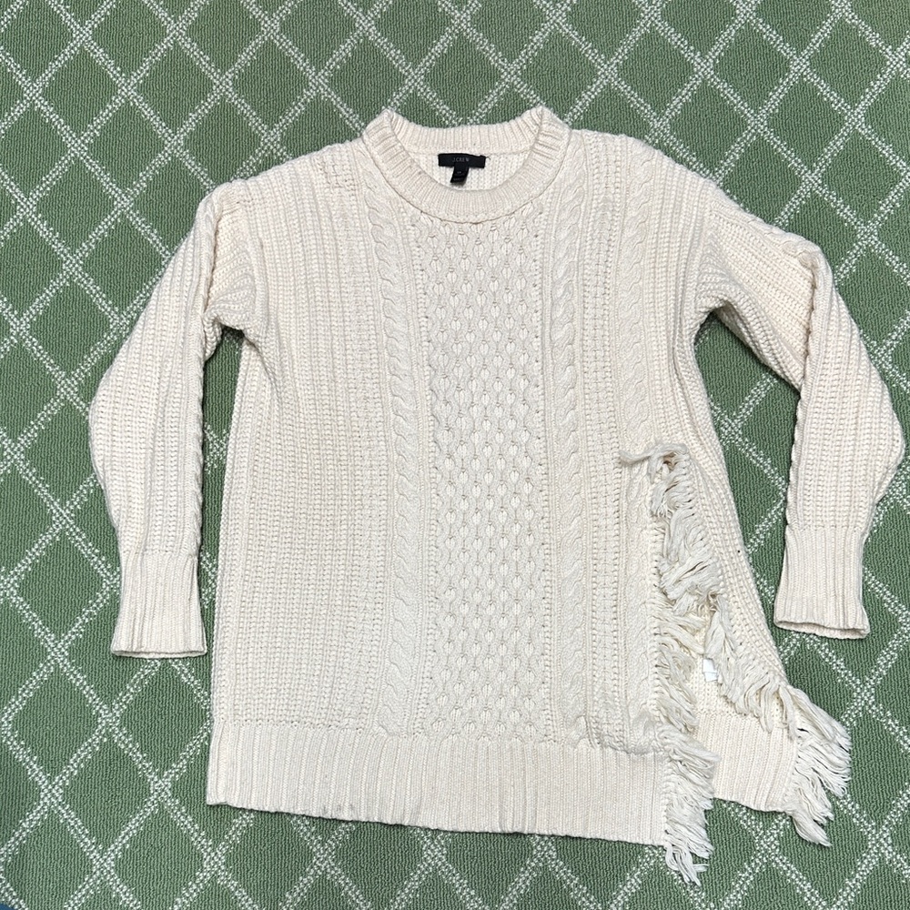 J Crew cream colored sweater with playful slit with fringe.